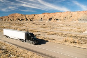 A truck on the road in a mountainous desert