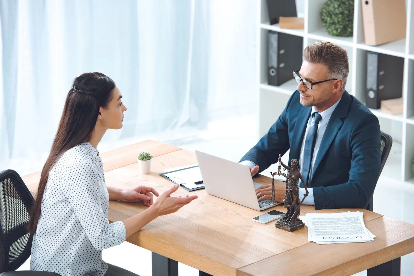 A man and a woman communicating at the desk